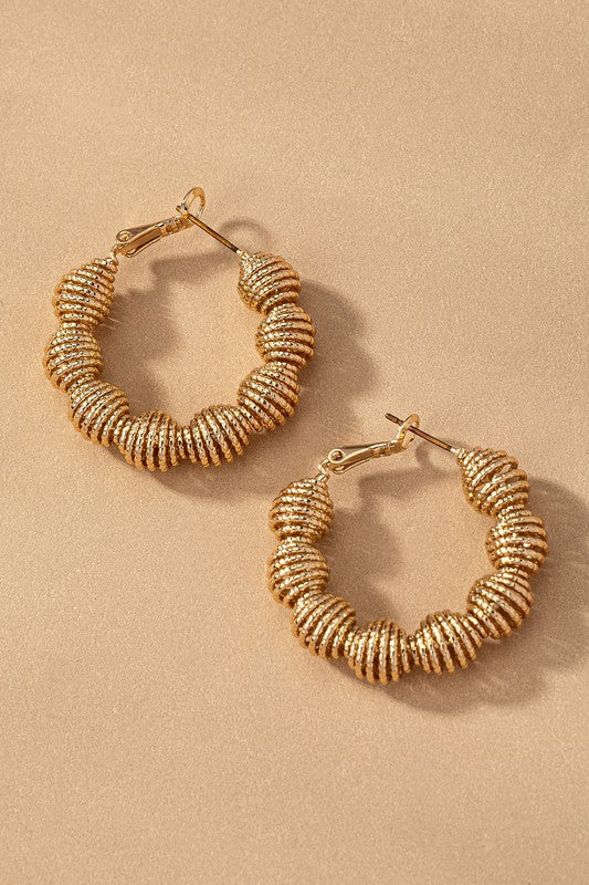Diamond cut wavy coil hoop earrings